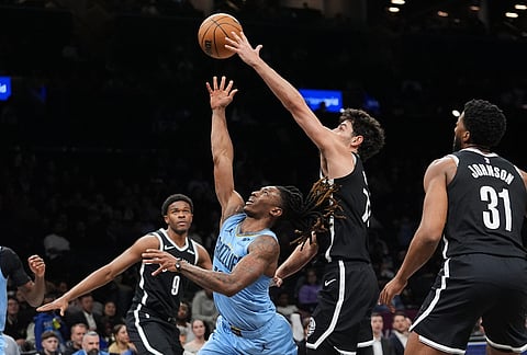 Memphis Grizzlies' Javon Small, center, drives past Brooklyn Nets' Ben Saraf, right, andE.J. Liddell during the second half of an NBA basketball game in New York.