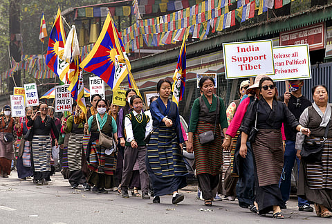 Tibetan people hold placards during a demonstration to mark the '67th National Uprising Day', in Dehradun, Uttarakhand.