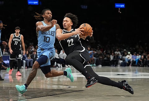 Memphis Grizzlies' Javon Small (10) defends Brooklyn Nets' Jalen Wilson (22) during the first half of an NBA basketball game in New York.