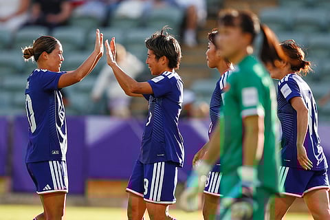 Japan's Riko Ueki is congratulated by teammate Fuka Nagano, left, after scoring her team's first goal during the Women's Asian Cup soccer match between Japan and Vietnam in Perth, Australia.