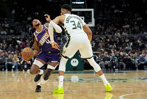 Phoenix Suns' Jalen Green (4) is fouled by Milwaukee Bucks' Giannis Antetokounmpo during the second half of an NBA basketball game, in Milwaukee.
