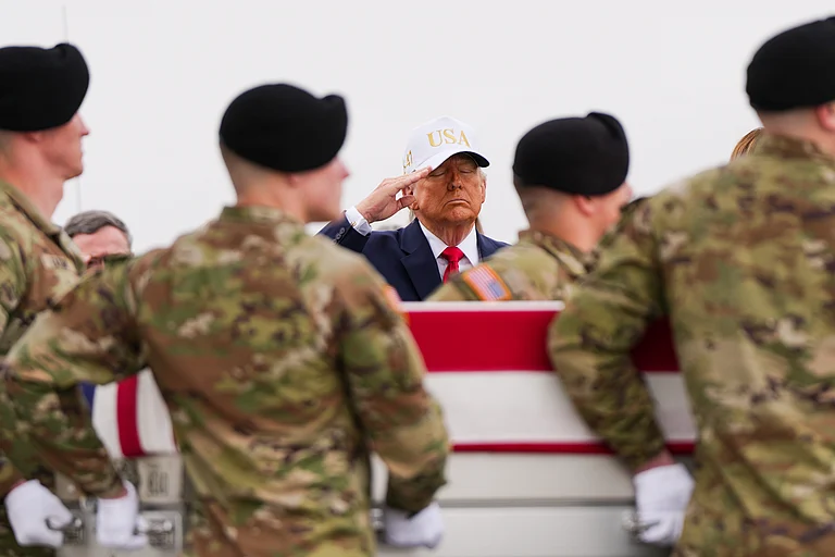 President Donald Trump salutes as an Army carry team moves a flag-draped transfer case with the remains of Sgt. Declan Coady, 20, of West Des Moines, Iowa, who was killed in a drone strike at a command center in Kuwait after the U.S. and Israel launched its military campaign against Iran, during a casualty return - AP/ Julia Demaree Nikhinson