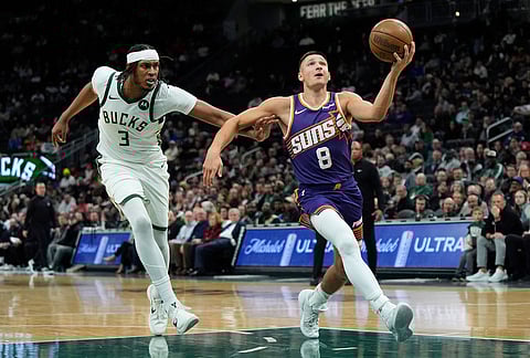Phoenix Suns' Grayson Allen (8) drives to the basket past Milwaukee Bucks' Myles Turner during the second half of an NBA basketball game in Milwaukee.
