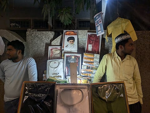 Shopkeepers in Zakir nagar placing the image of the late Supreme leader.