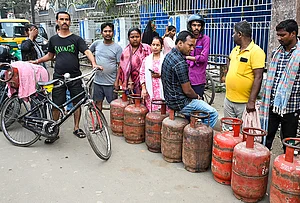| Photo: PTI : People queue up to book LPG cylinders at an Indane gas agency, in Patna, Bihar. Long queues were seen at several gas agencies amid an ongoing LPG supply shortage in the country.