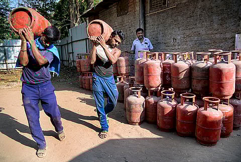 Workers load LPG cylinders at a depot following recent price hikes for both domestic and commercial units, in Nagpur, Maharashtra, Tuesday, March 10, 2026. 