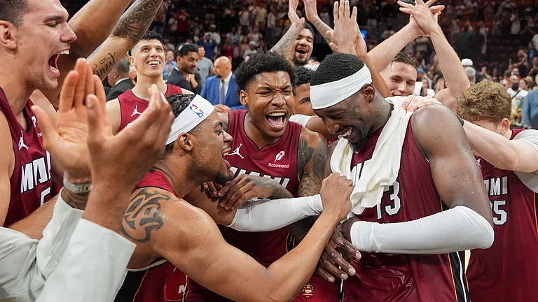 Bam Adebayo (13) celebrates with his teammates after record-breaking night. - AP