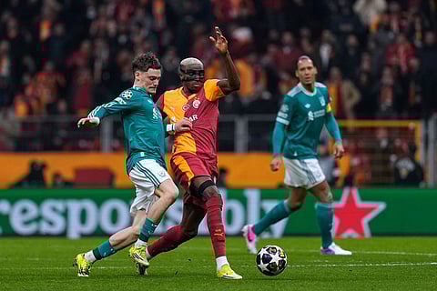 Liverpool's Alexis Mac Allister, left, vies for the ball with Galatasaray's Victor Osimhen during a Champions League round of 16 first leg soccer match between Galatasaray and Liverpool, in Istanbul, Turkey.