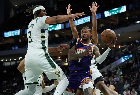 Phoenix Suns' Jalen Green, right, drives to the basket against Milwaukee Bucks' Myles Turner during the second half of an NBA basketball game in Milwaukee.