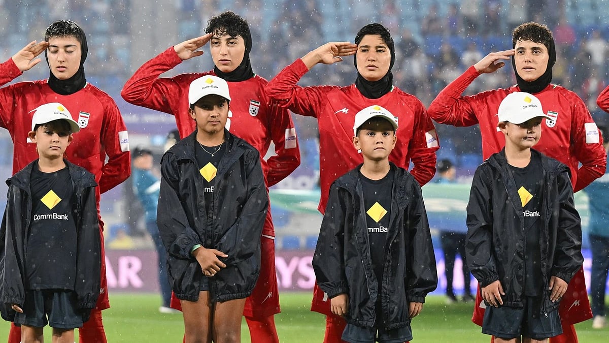 Iran women's team players salute during the national anthem. - AP