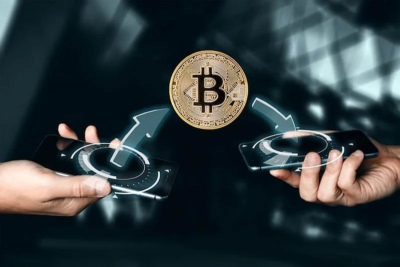 Bitcoin being sent between two mobile phones
