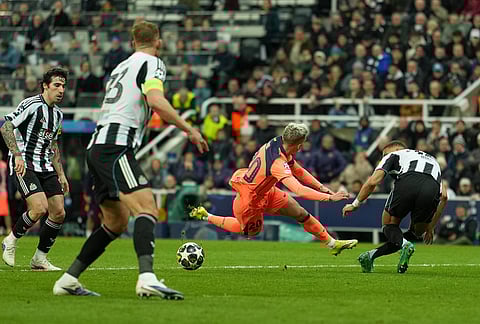 Barcelona's Dani Olmo is fouled and gets a penalty during the Champions League round of 16 first leg soccer match between Newcastle United and Barcelona in Newcastle, England.