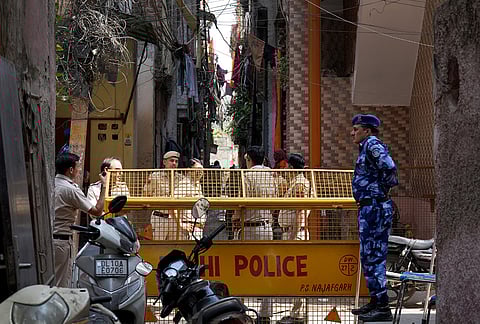 Police and CRPF personnel manning the barricades surrounding the houses of Tarun Kumar and the accused.