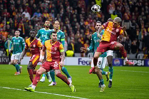 Galatasaray's Lucas Torreira, right, heads the ball during a Champions League round of 16 first leg soccer match between Galatasaray and Liverpool, in Istanbul, Turkey.