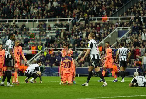 Barcelona's Dani Olmo is greeted by teammates after he was fouled and got a penalty during the Champions League round of 16 first leg soccer match between Newcastle United and Barcelona in Newcastle, England.
