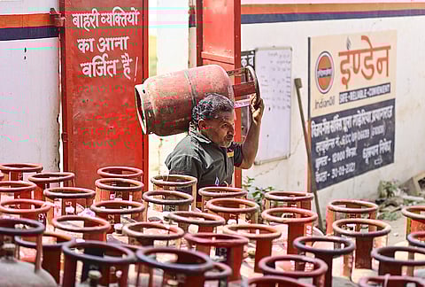 A worker carries an empty LPG cylinder at an Indane gas agency, in Prayagraj, Uttar Pradesh, Wednesday, March 11, 2026. 