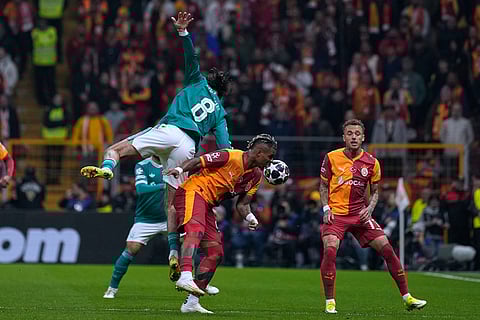 Liverpool's Dominik Szoboszlai, top, fights for the ball with Galatasaray's Mario Lemina during a Champions League round of 16 first leg soccer match between Galatasaray and Liverpool, in Istanbul, Turkey.