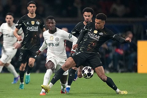 PSG's Desire Doue, right, and Chelsea's Moises Caicedo challenge for the ball during the first leg of the Champions League round of 16 soccer match between Paris Saint-Germain and Chelsea, in Paris.