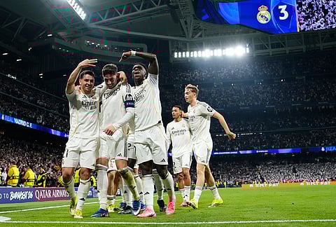 Real Madrid's Federico Valverde, center, celebrates after scoring his third goal during a first leg round of 16 Champions League soccer match between Real Madrid and Manchester City in Madrid, Spain.