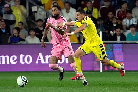 Inter Miami defender Micael dos Santos (16) and Nashville SC forward Cristian Espinoza (7) chase after the ball in the first half of a CONCACAF Champions Cup Round of 16 soccer match in Nashville, Tenn.