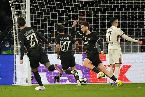 PSG's Khvicha Kvaratskhelia, second right, celebrates with teammates after scoring his side's fifth goal during the first leg of the Champions League round of 16 soccer match between Paris Saint-Germain and Chelsea, in Paris.