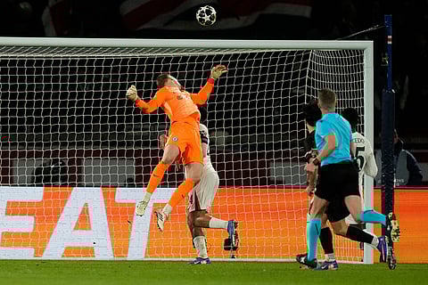 PSG's Vitinha scores his side's third goal during the first leg of the Champions League round of 16 soccer match between Paris Saint-Germain and Chelsea, in Paris.