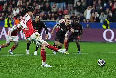 Arsenal's Kai Havertz scores a penalty, his side's first goal, during the Champions League round of 16 first leg soccer match between Bayer Leverkusen and Arsenal FC in Leverkusen, Germany.