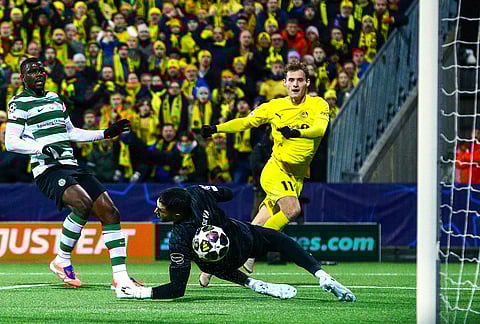 Bodo/Glimt's Ole Didrik Blomberg, right, scores their side's second goal of the game during the Champions League soccer match between Bodo/Glimt and Sporting Lisbon, in Bodo, Norway.