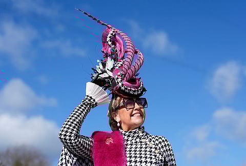 A racegoer attends Ladies Day of the 2026 Cheltenham Festival at Cheltenham Racecourse, England.
