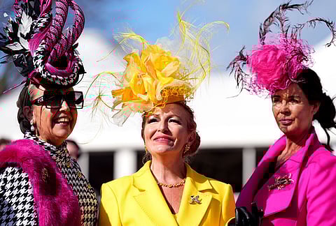 Racegoers attend Ladies Day of the 2026 Cheltenham Festival at Cheltenham Racecourse, England.