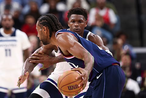 Minnesota Timberwolves guard Anthony Edwards, back, defends against Los Angeles Clippers forward Kawhi Leonard, front, during the second half of an NBA basketball game, in Inglewood, California.