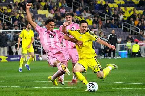 Nashville SC midfielder Alex Muyl (19) makes a shot as he is defended by Inter Miami's Ian Fray in the second half of a CONCACAF Champions Cup Round of 16 soccer match in Nashville, Tenn.