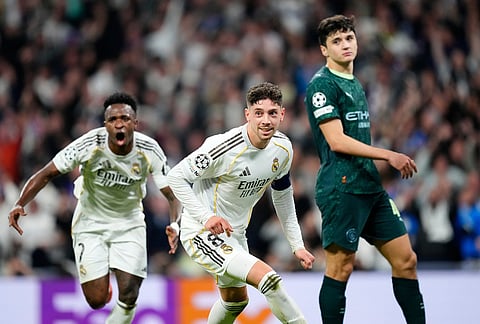 Real Madrid's Federico Valverde, center, celebrates after scoring during a first leg round of 16 Champions League soccer match between Real Madrid and Manchester City in Madrid, Spain.