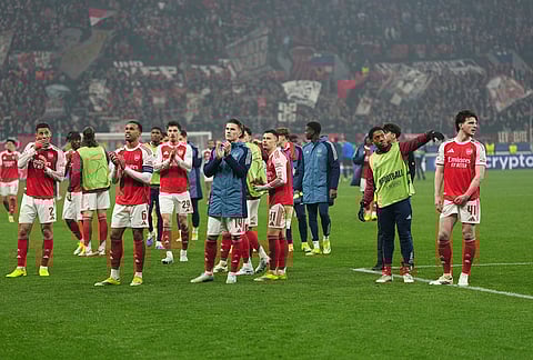 Arsenal players applaud their team's fans after the Champions League round of 16 first leg soccer match between Bayer Leverkusen and Arsenal FC in Leverkusen, Germany.
