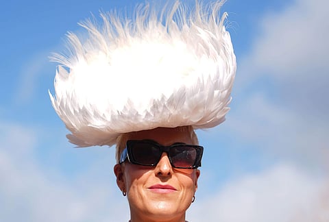 A racegoer attends Ladies Day of the 2026 Cheltenham Festival at Cheltenham Racecourse, England.
