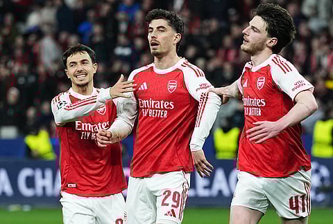 Arsenal's Kai Havertz, center, celebrates reserved beside Arsenal's Declan Rice, right, and Arsenal's Martin Zubimendi, left, after scoring a penalty against his former club during the Champions League round of 16 first leg soccer match between Bayer Leverkusen and Arsenal FC in Leverkusen, Germany.