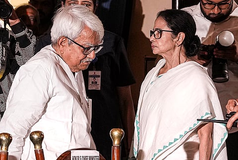 West Bengal Chief Minister Mamata Banerjee, right, interacts with Left Front Chairman Biman Bose during a swearing-in ceremony, at Lok Bhavan in Kolkata, West Bengal.