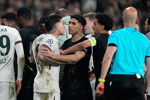 Chelsea's Enzo Fernandez, center left, argues with PSG's Achraf Hakimi, center, and PSG's Marquinhos during the first leg of the Champions League round of 16 soccer match between Paris Saint-Germain and Chelsea, in Paris.