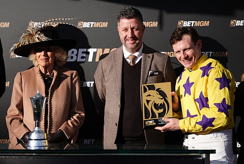 Britain's Queen Camilla presents a trophy to winning jockey Paul Townend after Il Etait Temps won the Queen Mother Champion Chase on day two of the 2026 Cheltenham Festival at Cheltenham Racecourse, in Cheltenham, England.