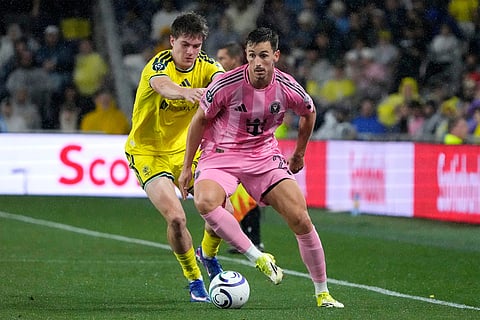 Nashville SC midfielder Reed Baker-Whiting, left, defends against Inter Miami forward Tadeo Allende, right, in the second half of a CONCACAF Champions Cup Round of 16 soccer match in Nashville, Tenn.