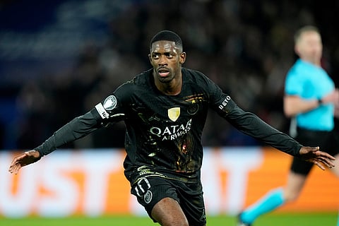 PSG's Ousmane Dembele celebrates after scoring his side's second goal during the first leg of the Champions League round of 16 soccer match between Paris Saint-Germain and Chelsea, in Paris.