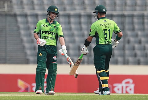 Pakistan's Sahibzada Farhan and batting partner Maaz Sadaqat touch bats after hitting a boundary during the first one day international cricket match between Bangladesh and Pakistan in Mirpur, Bangladesh.