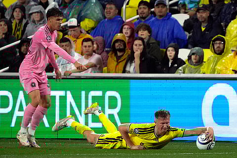 Inter Miami defender Noah Allen, left, protests a play by Nashville SC forward Sam Surridge, right, in the first half of a CONCACAF Champions Cup Round of 16 soccer match in Nashville, Tenn.
