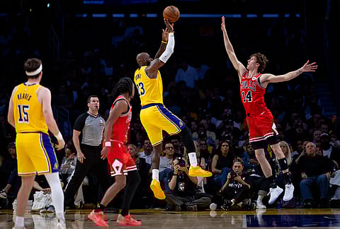 Los Angeles Lakers forward LeBron James (23) shoots against Chicago Bulls forward Matas Buzelis (14) during the second half of an NBA basketball game, in Los Angeles.