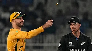 | Photo: AP/Anupam Nath : South Africa's captain Aiden Markram tosses the coin for toss as New Zealand's captain Mitchel Santner watches at the start of the first T20 World Cup cricket semifinal.