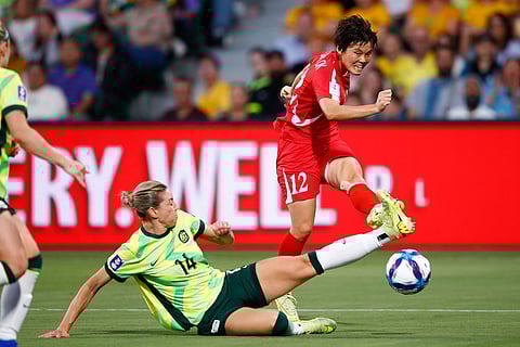 Australia's Alanna Kennedy attempts to block the shot on goal from North Korea's Hong Song Ok, right, during the Women's Asian Cup quarterfinal soccer match between Australia and North Korea in Perth, Australia.