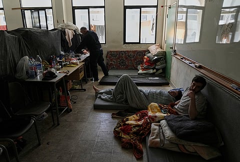 Displaced people fleeing Israeli airstrikes in southern Lebanon settle at the Bir Hassan Technical Institute, which has been turned into a shelter, in Beirut, Lebanon, Wednesday, March 11, 2026. 