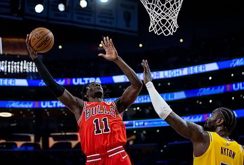 Chicago Bulls forward Leonard Miller is defended by Los Angeles Lakers center Deandre Ayton (5) during the second half of an NBA basketball game, in Los Angeles. 