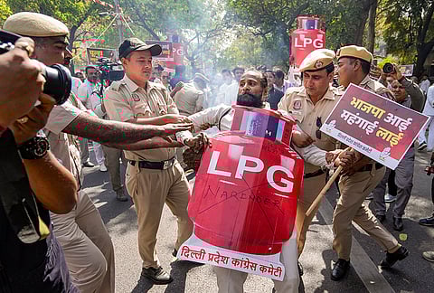 Police personnel detain a Delhi Pradesh Congress Committee (DPCC) member during a protest over the ongoing 'LPG crisis' in the country, in New Delhi.