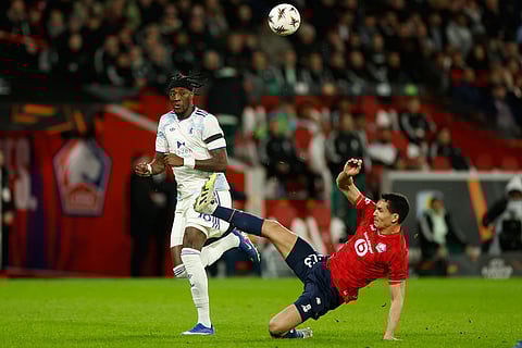 Lille's Aïssa Mandi clears the ball in front of Aston Villa's Tammy Abraham during a first leg, round of 16 Europa League soccer match between Lille and Aston Villa in Lille, France.